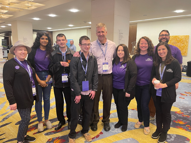 A group poses for a photo at the 2023 Neurodiversity in the Workplace Conference.