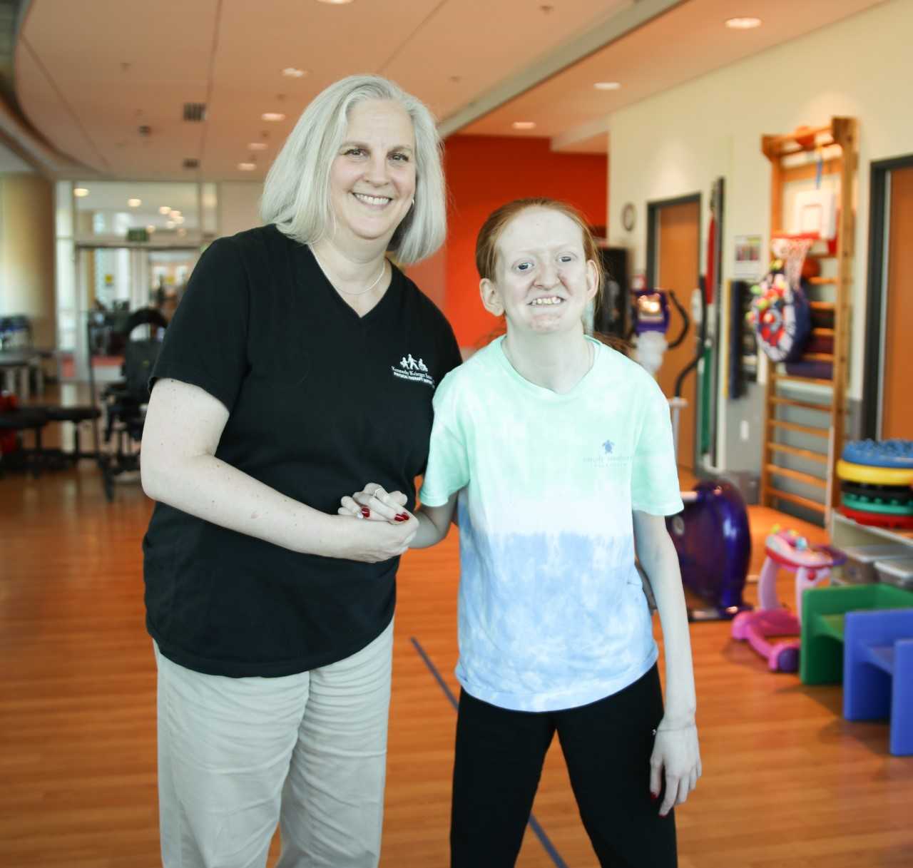 Heather McLean, Kennedy Krieger physical therapist, with Ellie