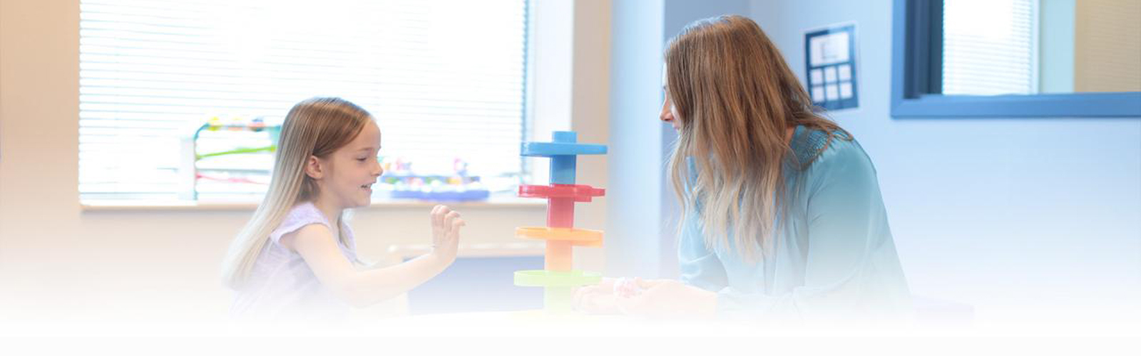 A teacher works with one her students in a classroom.