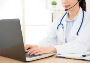 A doctor working on a computer