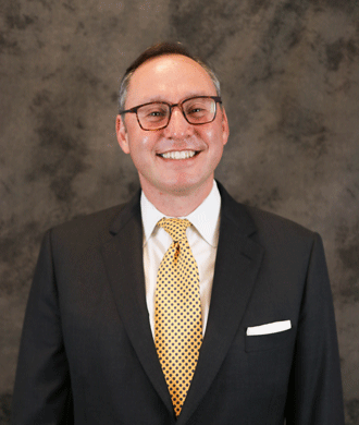 A posed headshot photo of Dr. Joshua Ewen.