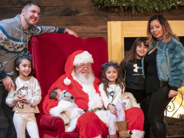 Family takes photo with Santa Claus