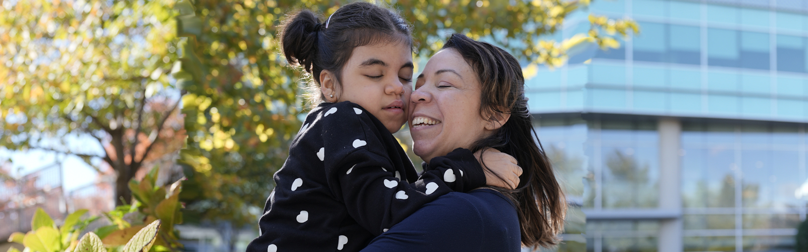 Violet stands with her mother in the Kennedy Krieger garden. 