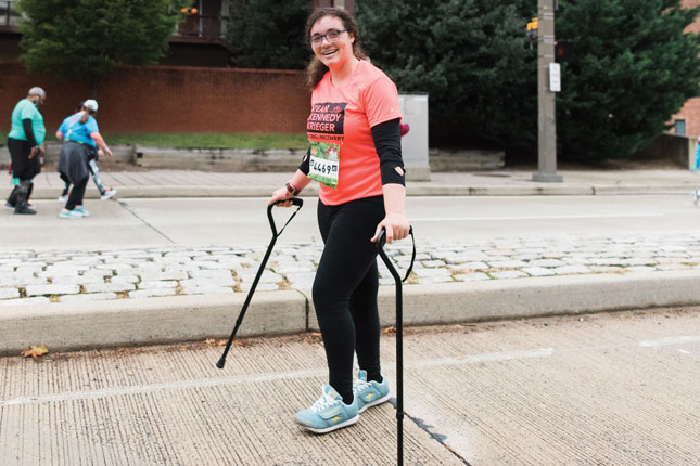 A female adaptive sports athlete participates in the Baltimore Running Festival as a member of Team Kennedy Krieger. 
