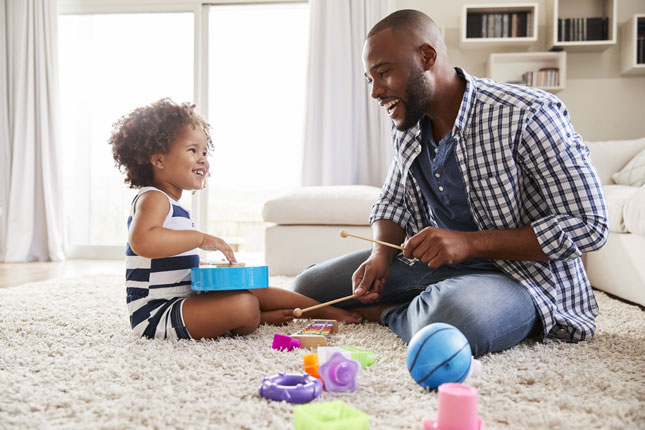A father plays with his toddler.