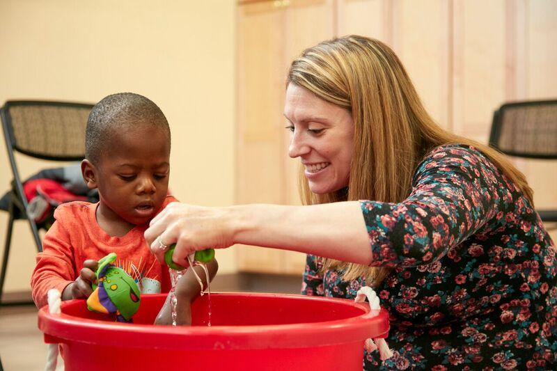 A therapist assists a patient during speech therapy.