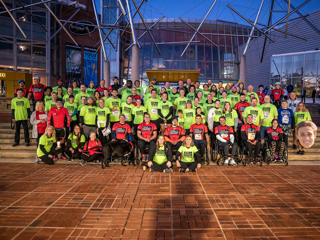 Team Kennedy Krieger poses for a photo in front of the Maryland Science Center before the 2022 Baltimore Running Festival.