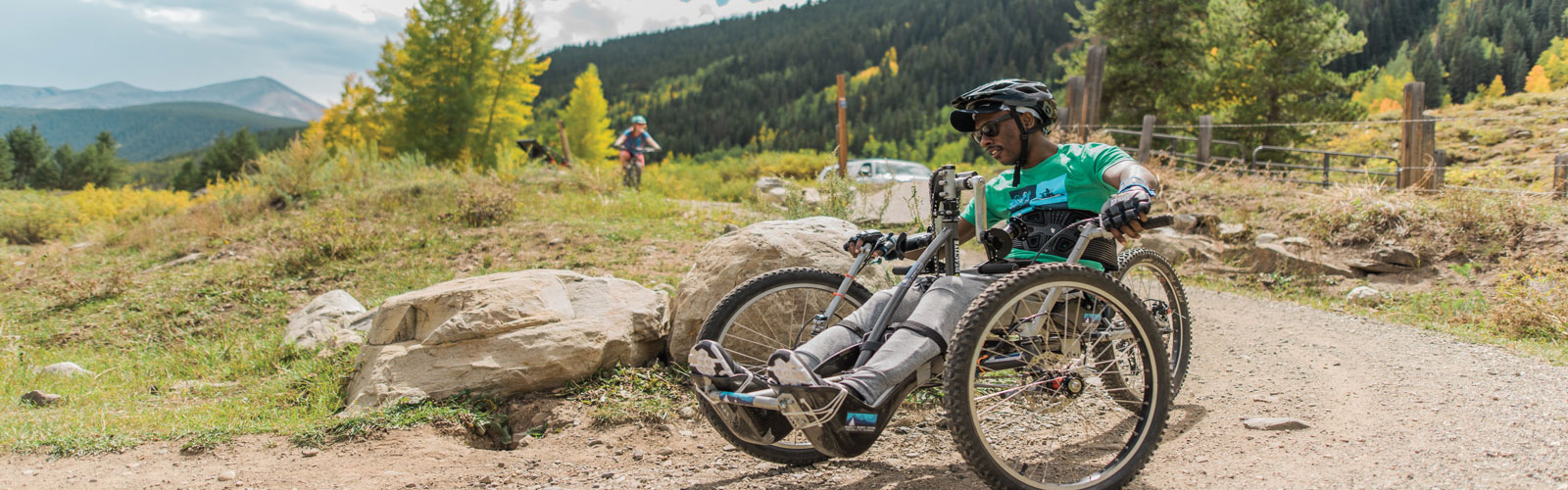 A man in a handcycle outside.