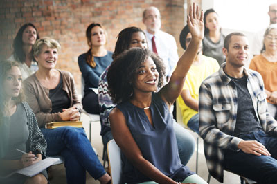 A group of adults learning in a classroom.