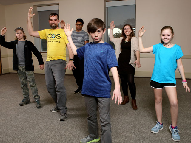 Children and adults participate in Tai-Chi training. 