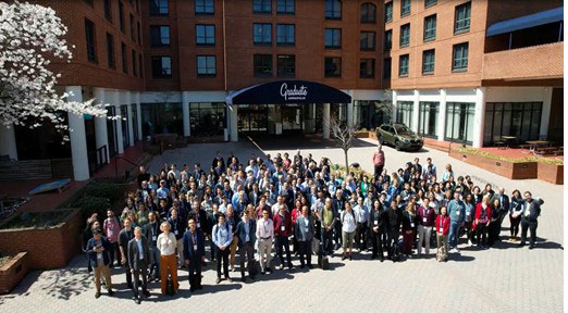 A large group stands outside of the Graduate Hotel in Annapolis, MD.