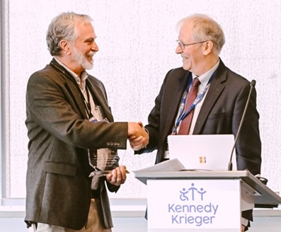 Joe Gillen shakes Dr. Peter C.M. van Zijl's hand as he receives an exceptional performance award.