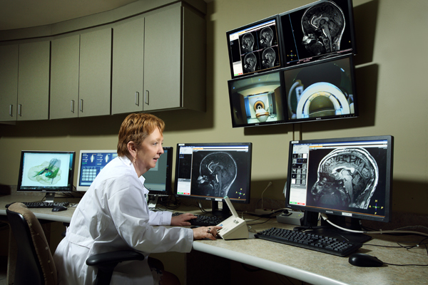 An investigator works at monitors in her research lab. 