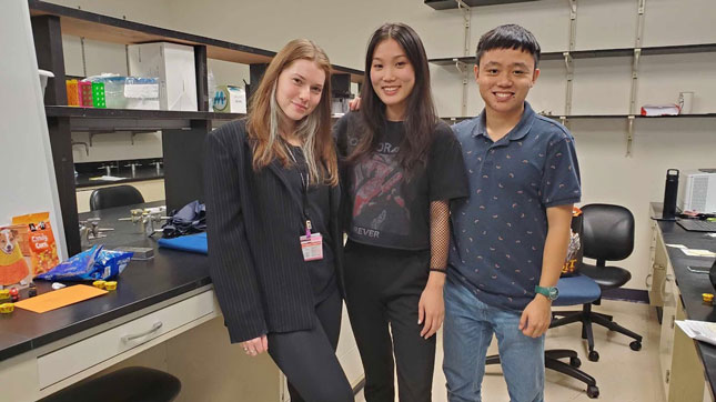 Three members of the Opendak Lab team. The photo features two women, plus a man standing to the right. 