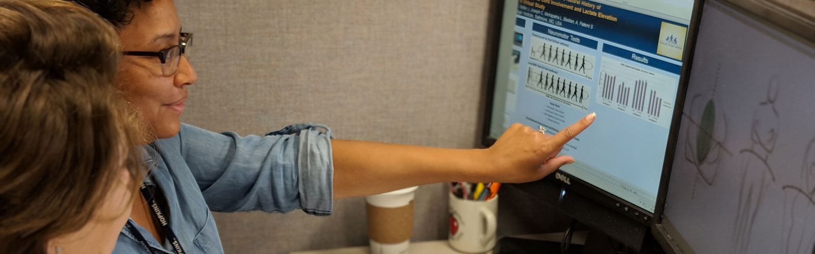 Researchers at Kennedy Krieger review data on a monitor. 