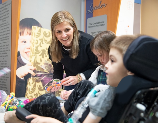 Dulany and her daughter, Madeline, meet with Julian,  a patient at Kennedy Krieger, while volunteering with the Institute’s Child Life and Therapeutic Recreation Department