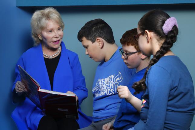 Nancy Grasmick reads to a group of children.