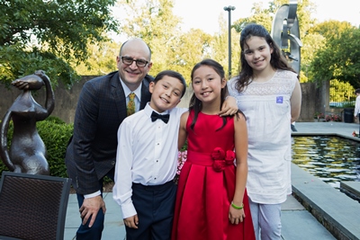 Bradley L. Schlaggar, MD, PhD, president and CEO of Kennedy Krieger; Matthew Schneider; Maggie Schneider; and Lena Schlaggar at the  reception following Maggie and Matthew’s 2019 benefit concert.