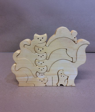This wooden puzzle has eight interlocking cats and one mouse.