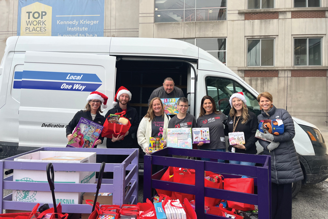 Kennedy Krieger volunteers and staff members collect toy drive donations.