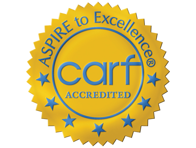 An icon shaped like an award seal that says: “Aspire to Excellence—CARF Accredited.”