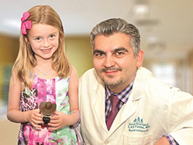 Kennedy Krieger patient Ellie McGinn poses with her doctor, Dr. Ali Fatemi