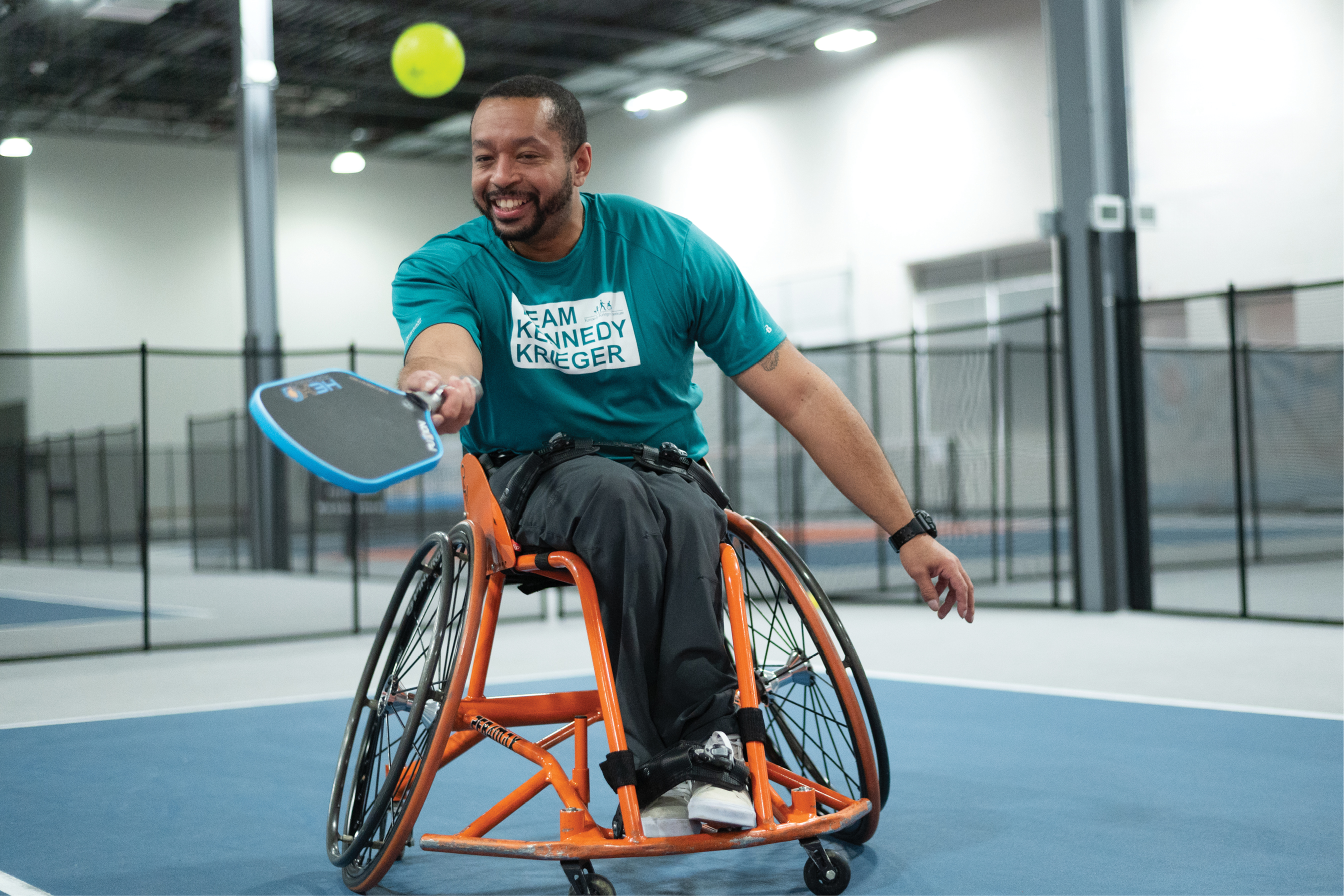 A male adaptive sports athlete plays pickleball. 