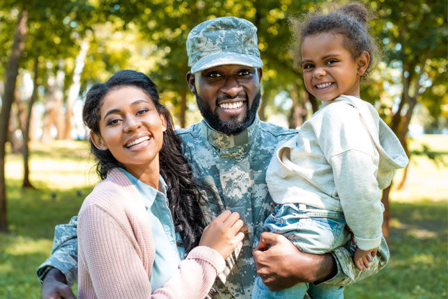A soldier with his wife and young daughter.