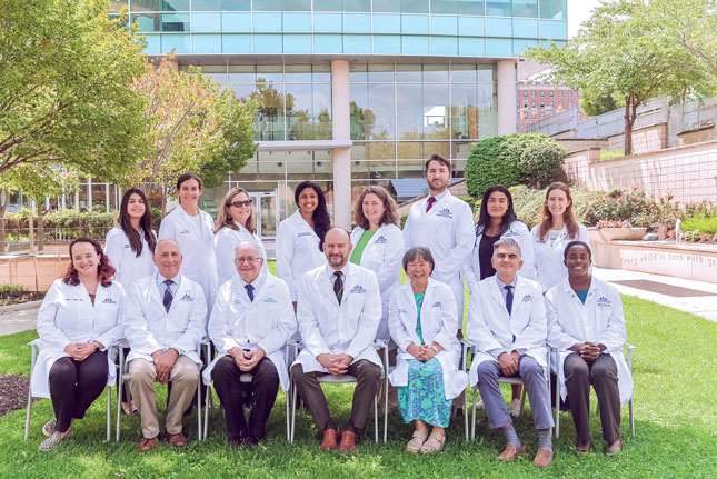 A large group of doctors in Kennedy Krieger's therapy garden.