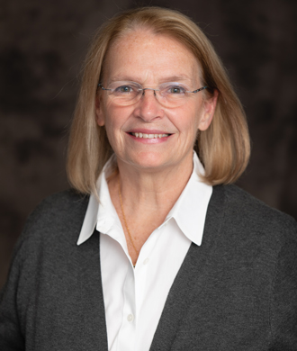 Posed photo of a smiling woman in business attire