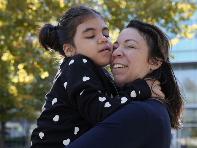 Violet hugs her mom, Inez.