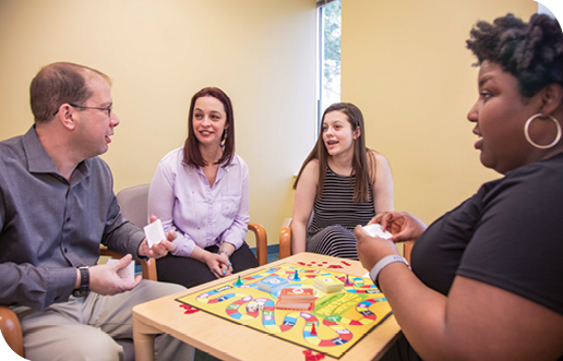 Todd, Amanda, Addison and Dr. Culpepper play a board game during the session.