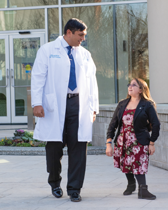 Dr. Mahim Jain, of Kennedy Krieger’s Osteogenesis Imperfecta Clinic, talks with Shannon in the Institute’s Therapeutic Healing Garden.