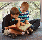 Alex reads a story to his cousin Corey