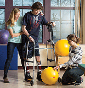 Greg with physical therapist Kate Hill and trainee Amy Albano