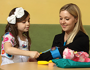 Child Life specialist Shereé Sheffer works with Kat.