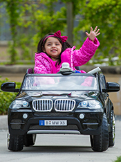 Sophia waves to the camera from her car