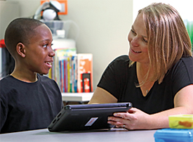 Mikey works with his teacher, Gabriela Bandi, at Kennedy Krieger High School.