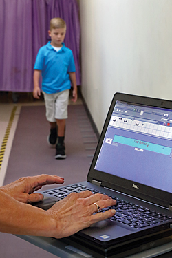 At Kennedy Krieger’s outpatient center, Nathaniel walks on a special mat that records his gait on a computer.