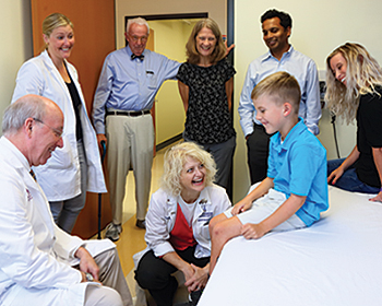 At Kennedy Krieger’s outpatient center, Nathaniel walks on a special mat that records his gait on a computer.