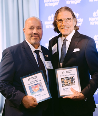 A representative of AHEPA Lord Baltimore Chapter #364 and Jared Culotta smile while holding their awards from the Society Reception.