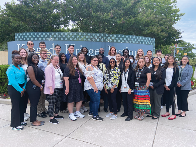 A group photo of trainees standing outside of Kennedy Krieger Institute.