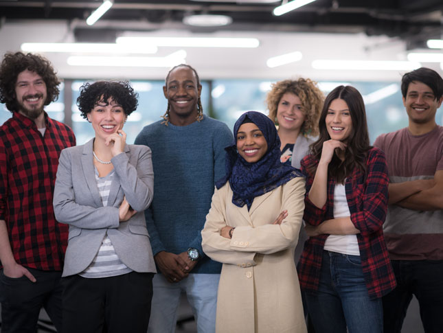 A diverse group of young professionals in an office. 