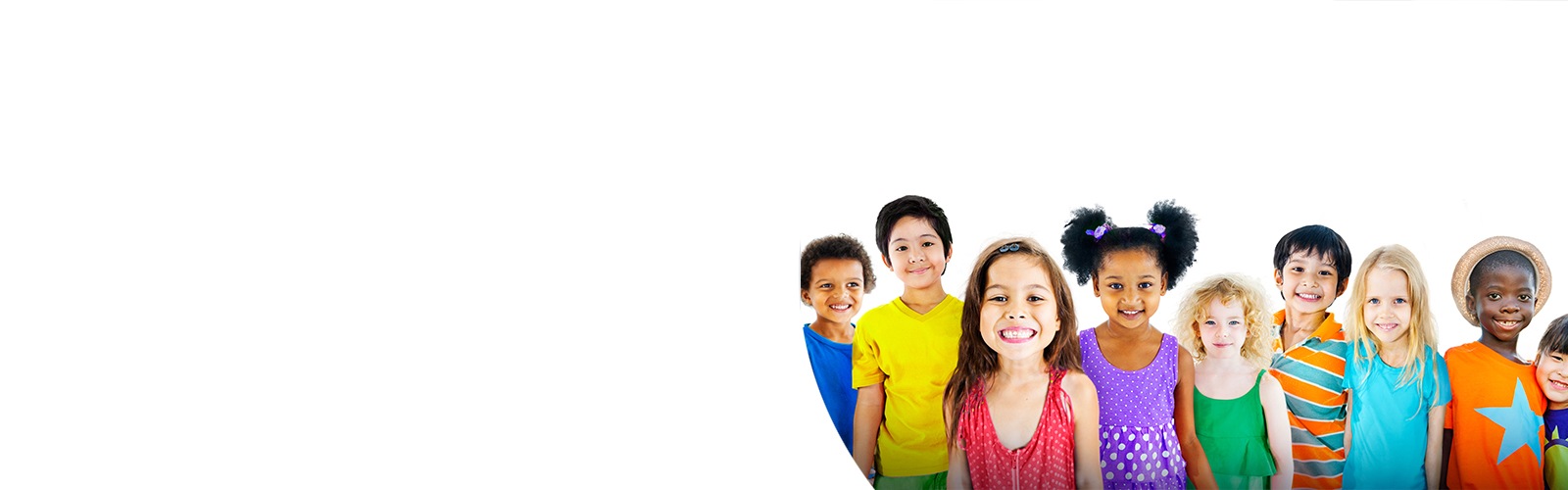 A group of small children smiling while standing in a row.