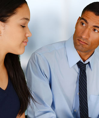 A psychologist listens to his patient, a teenaged girl.