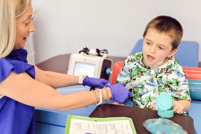A young boy receives therapy from a SLP at the FIT Program