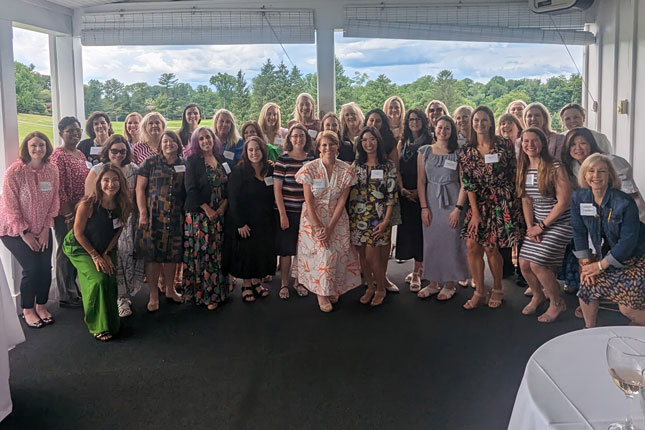 Dozens of attendees in a group photo at a WIN gathering.