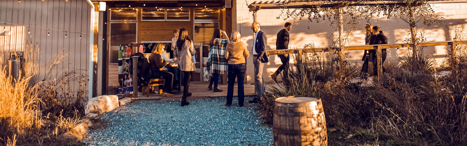A group of people stand outside during Barrels & Bonfires.