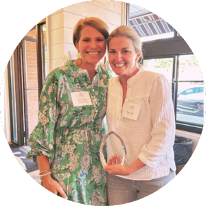 Dulany Dent holds Lainy Lebow Sachs award. She stands to the right, with Allyson Peters, a Kennedy Krieger Foundation employee, standing to her left.