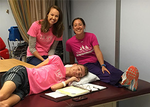 Spine patient laying down in front of therapists.